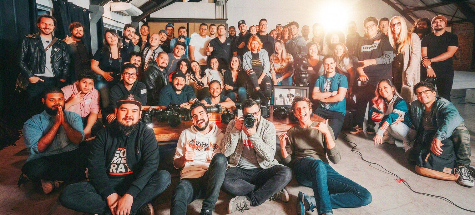 A group gathered around cameras and a worktable at Revolver Studios.